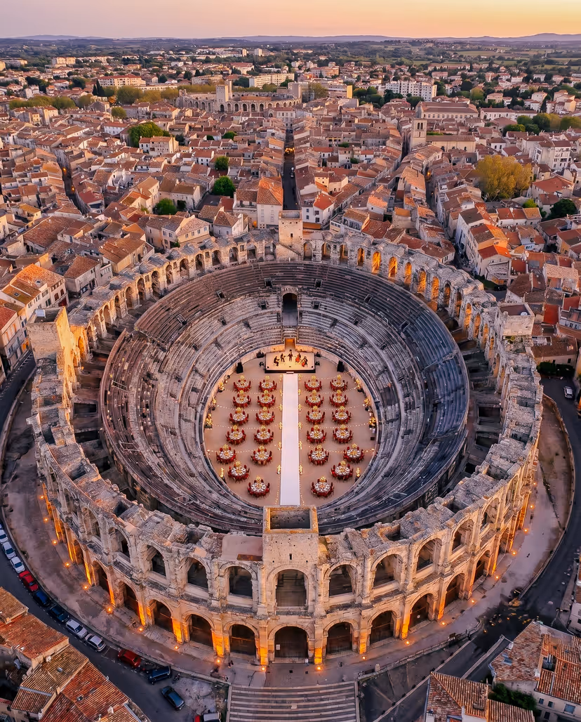 Aerial view of a private dinner inside the Arènes d'Arles at sunset