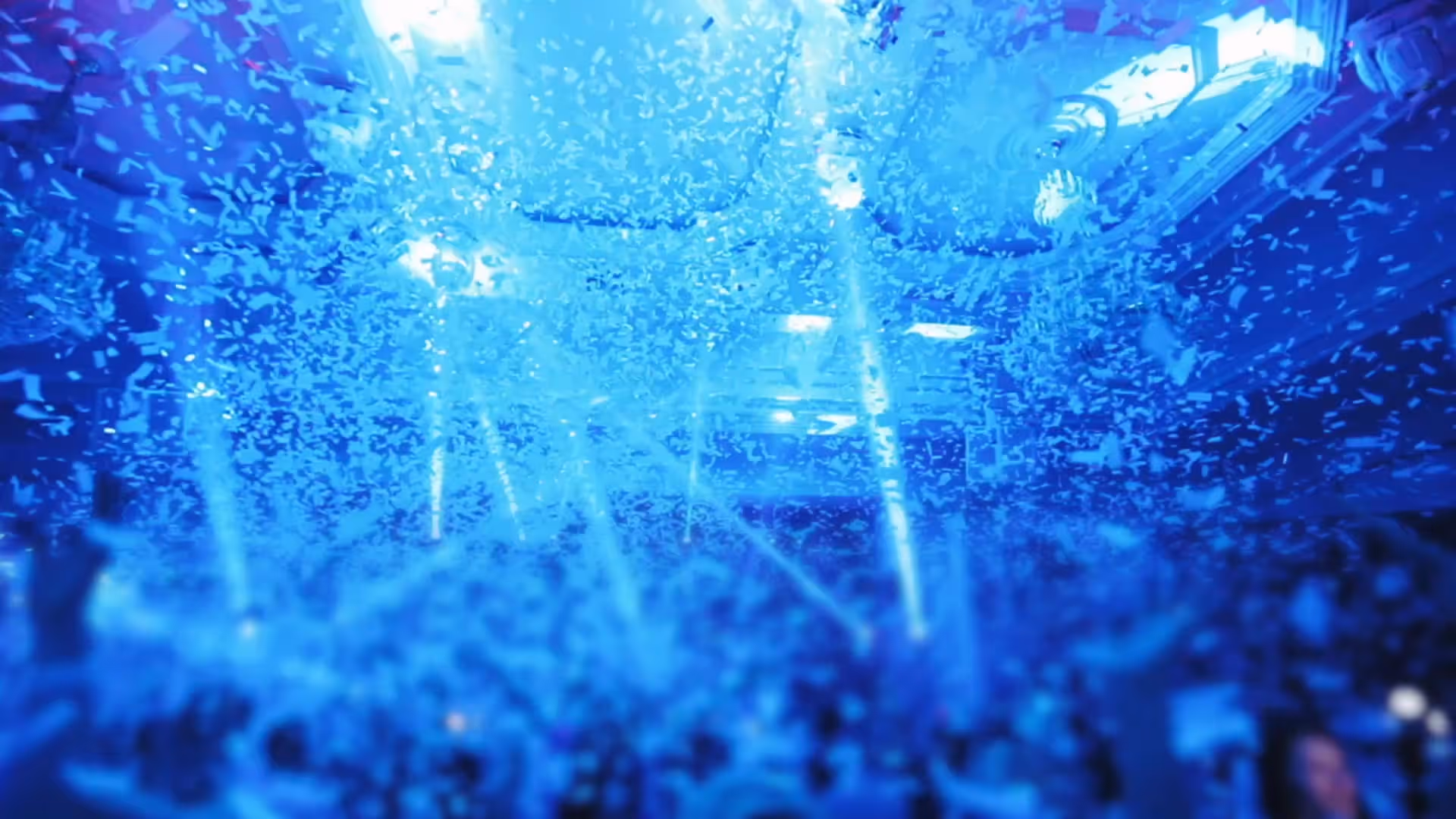 Confetti rain and blue stage lights at a private festival wedding in Provence