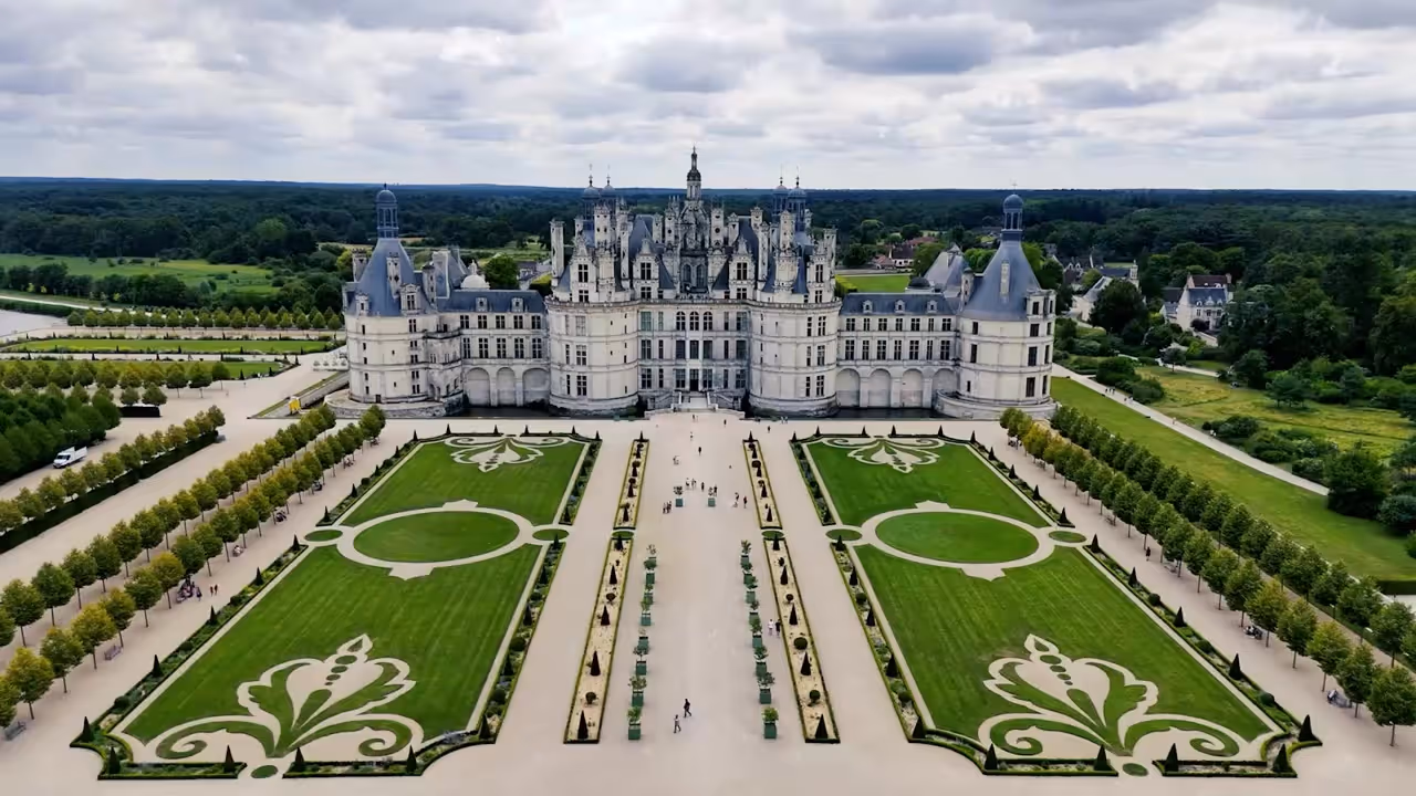 Château de Chambord seen from above, its towers above symmetrical formal gardens in the Loire Valley