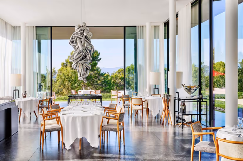 Restaurant Louison dining room with sculpture and Luberon views, Villa La Coste