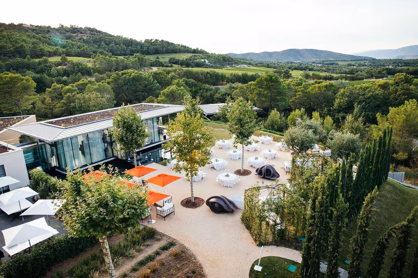Aerial view of wedding dinner among sculptures, Villa La Coste